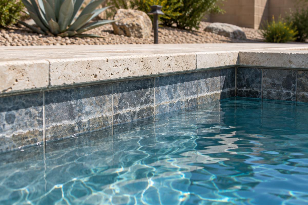 Lower pool water level beneath a mineral line on tile at a Gilbert, Arizona home.